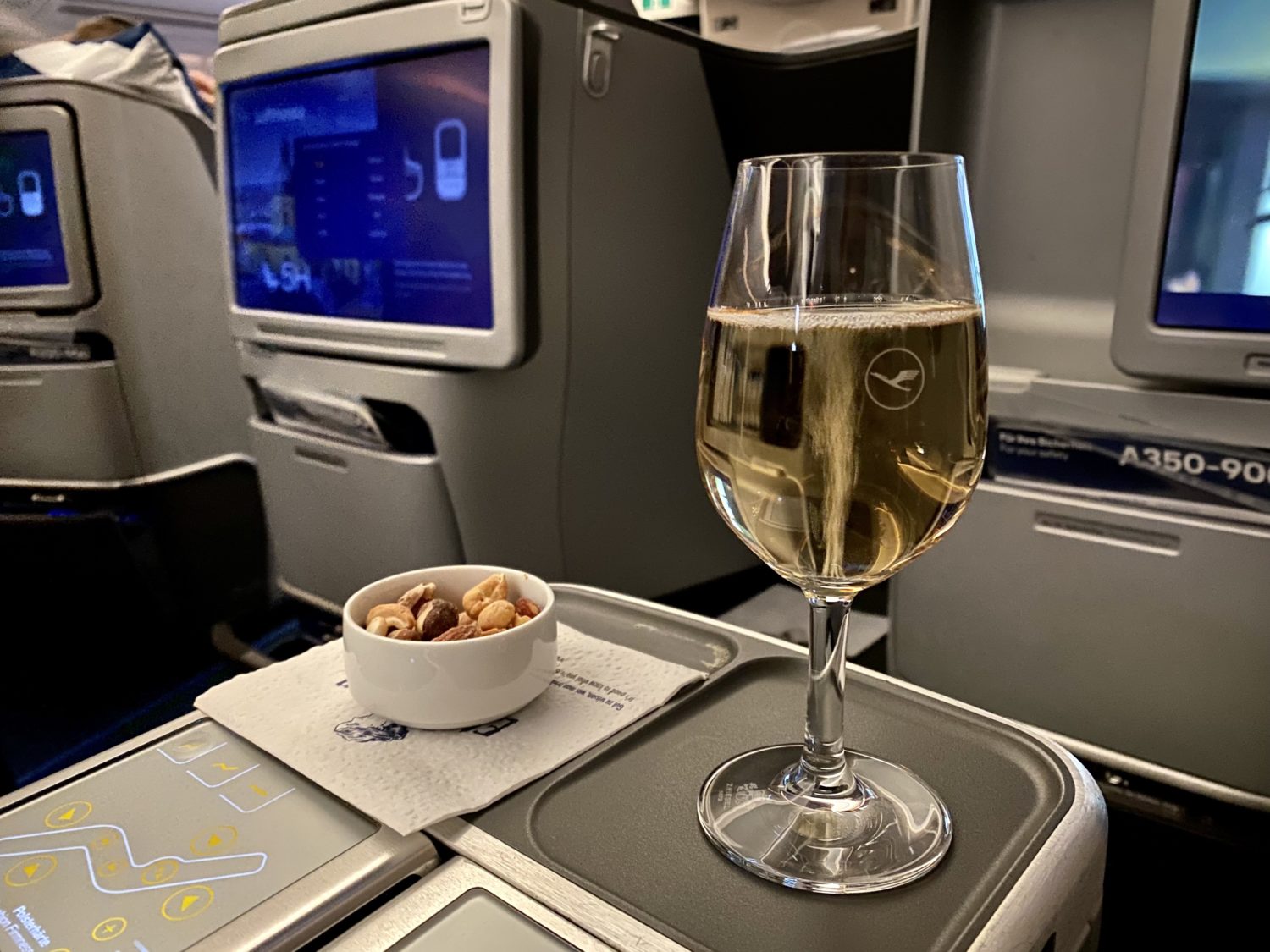 a glass of champagne and ramekin of nuts