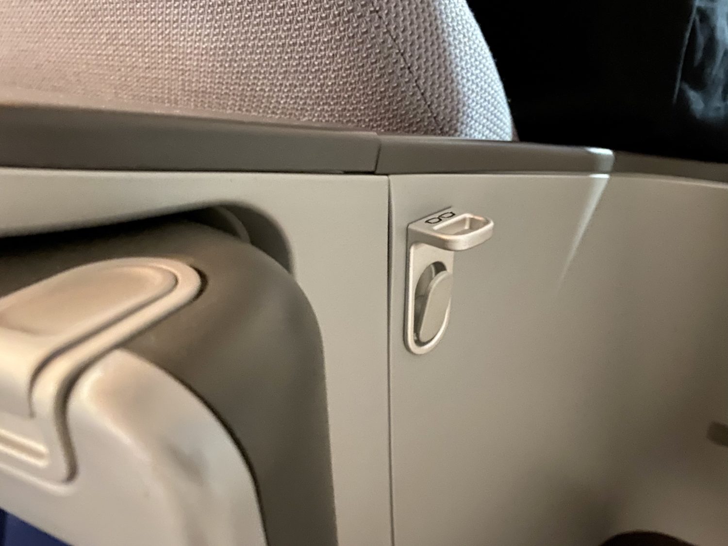 glasses rest built into a plane seat