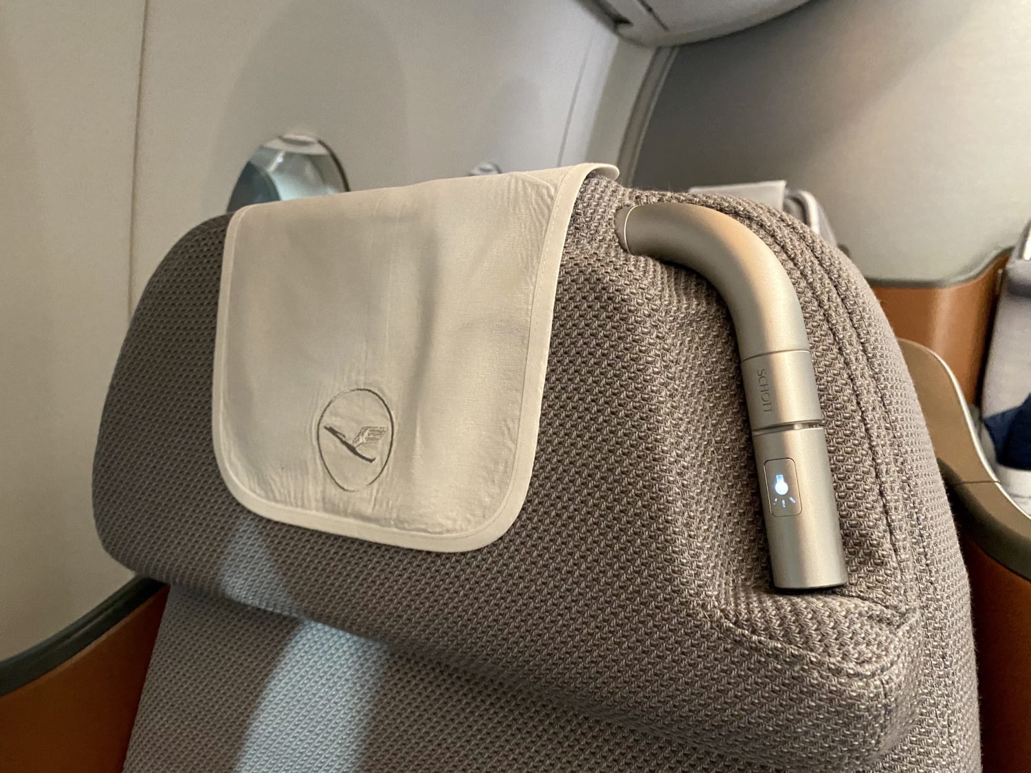 headrest and reading lamp on a business class seat