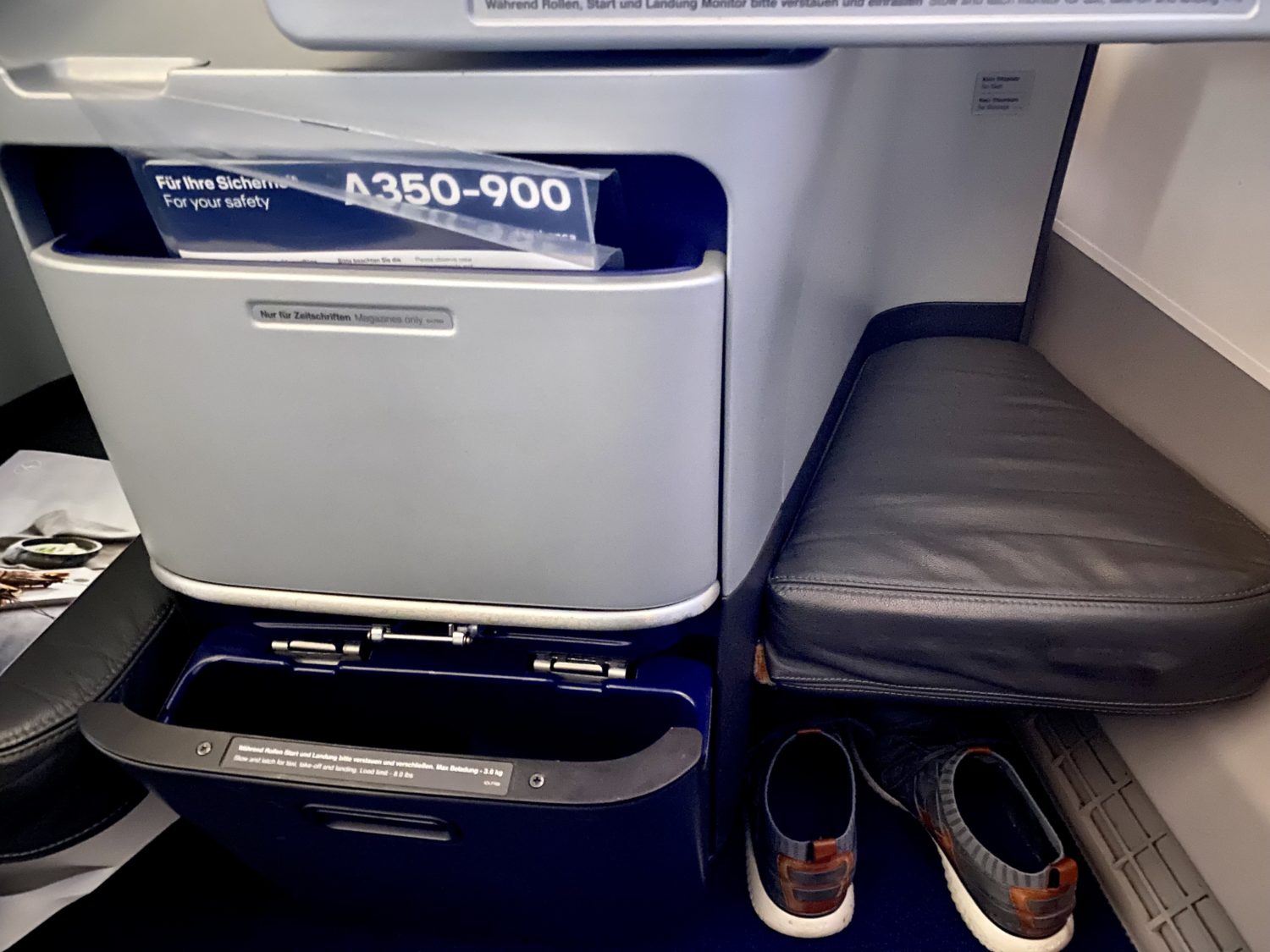 shoes underneath a business class ottoman