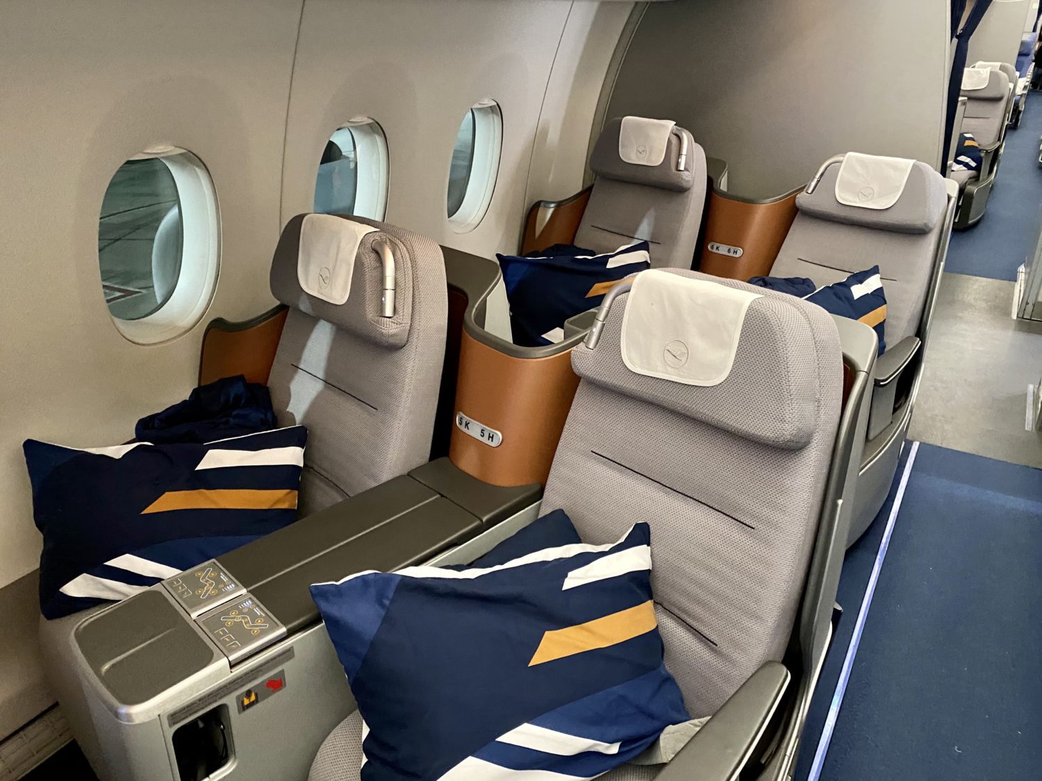 business class seats with pillows on them