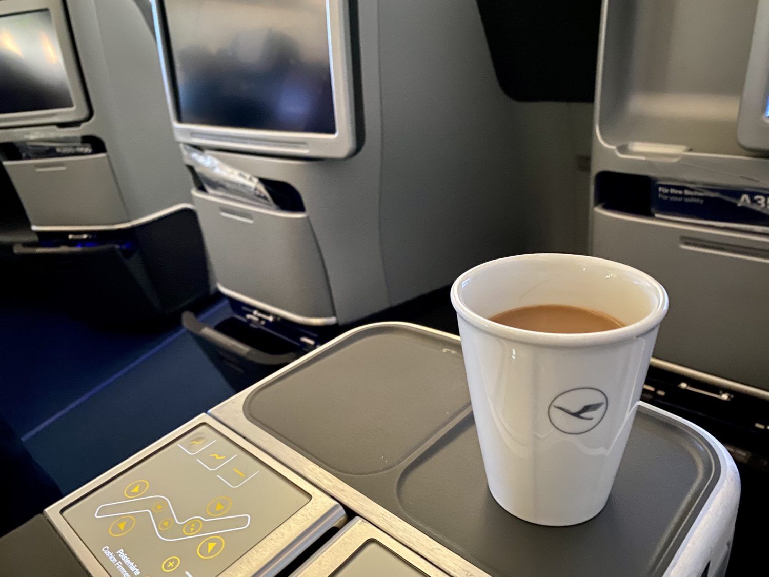 glass of coffee on a business class seat
