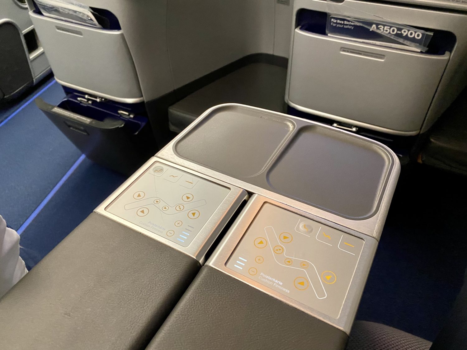 seat controls and console table on a plane