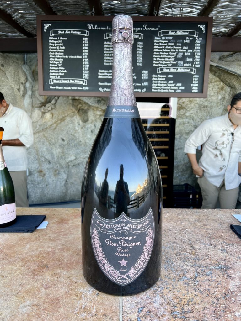 a large bottle of dom perignon champagne sitting on a bar