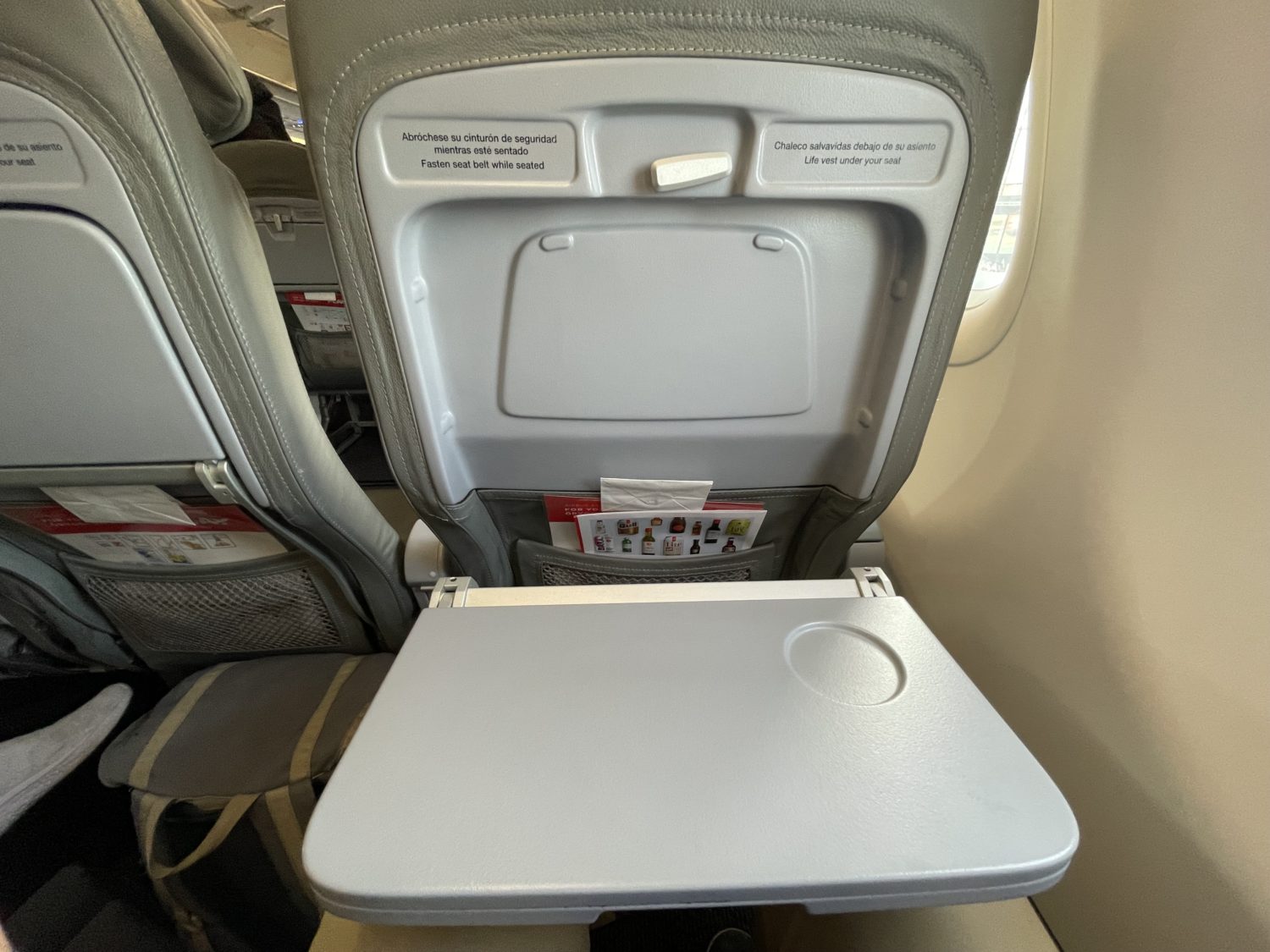airplane seat with the tray table extended