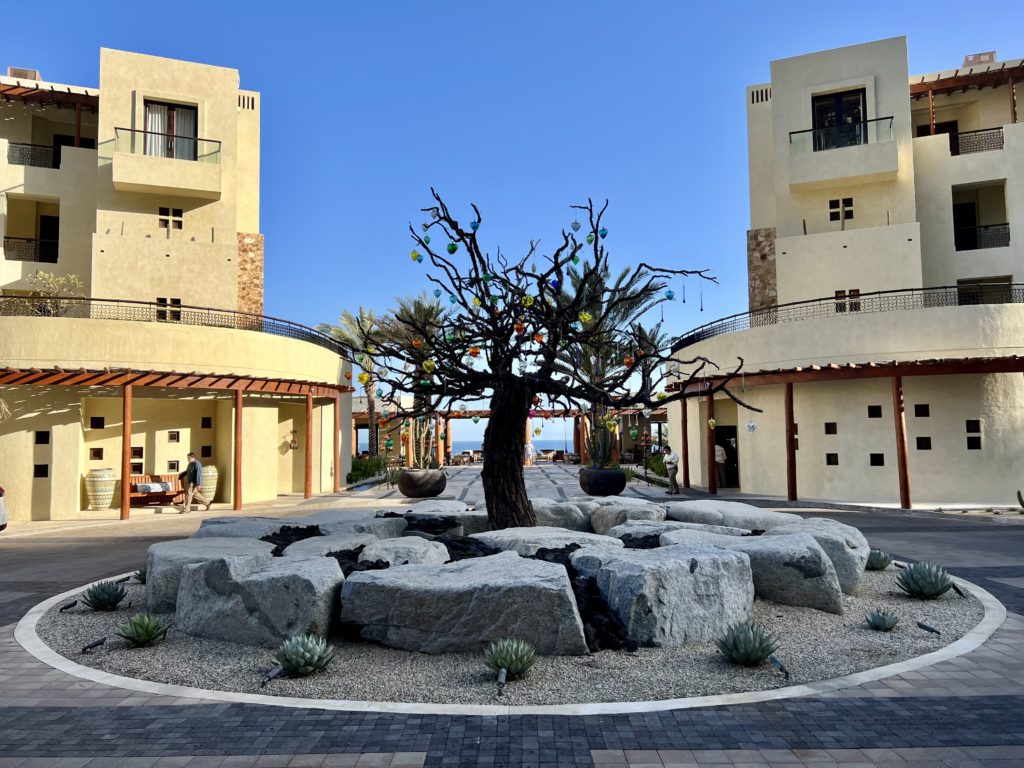 a circular driveway with a decorated tree in the middle