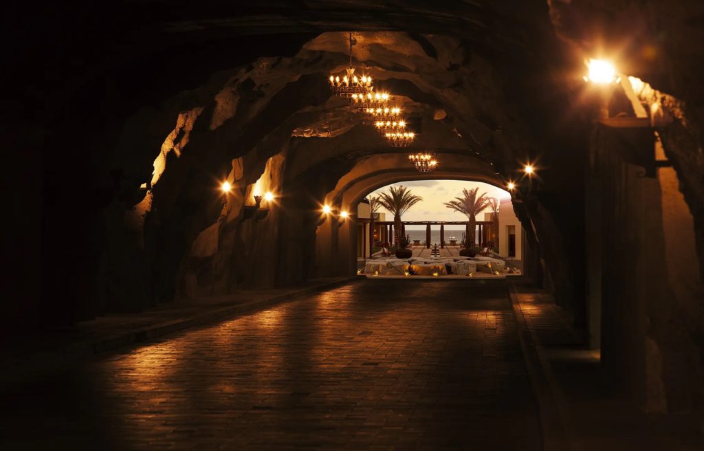 a long dark tunnel with a light at the end