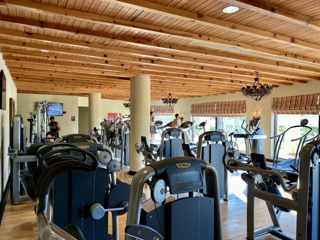 a fitness center with many different pieces of equipment