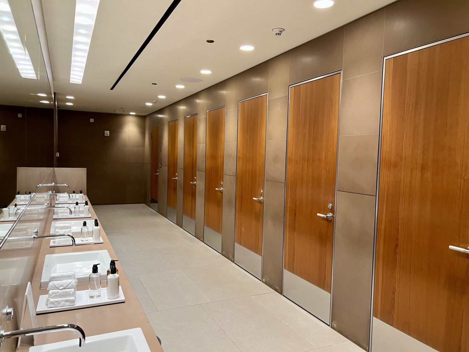 rows of bathroom doors and sinks