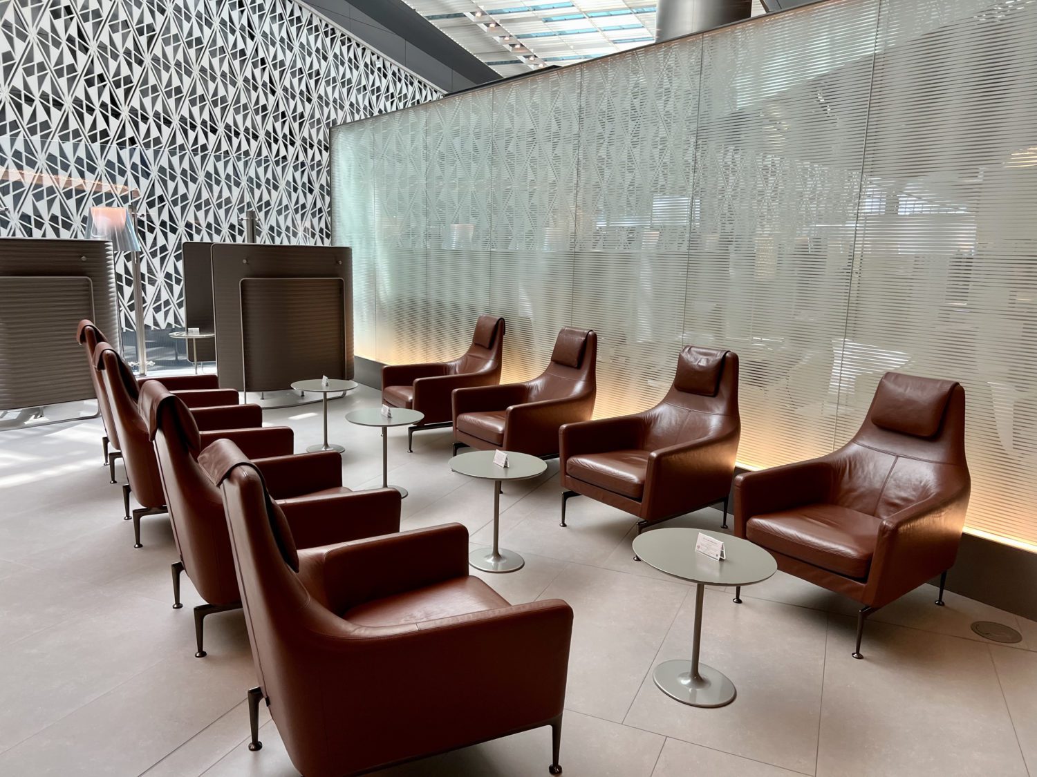 eight red leather chairs sitting face to face