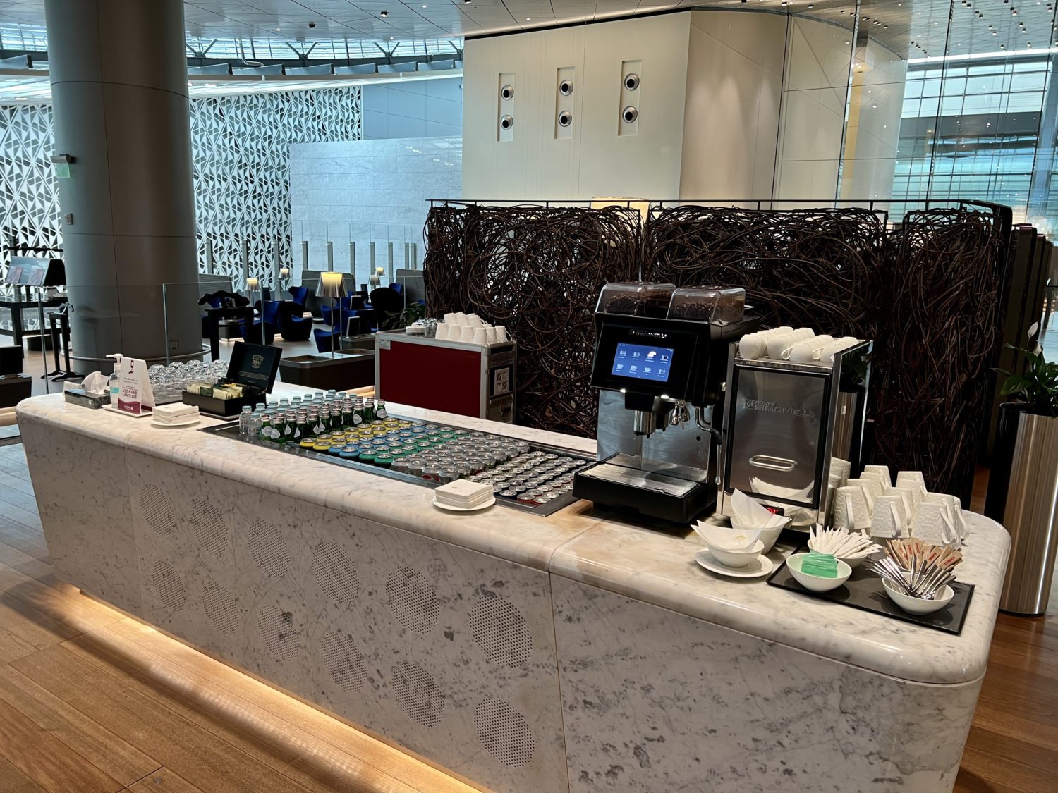 drink station with bottles of water and coffee machine