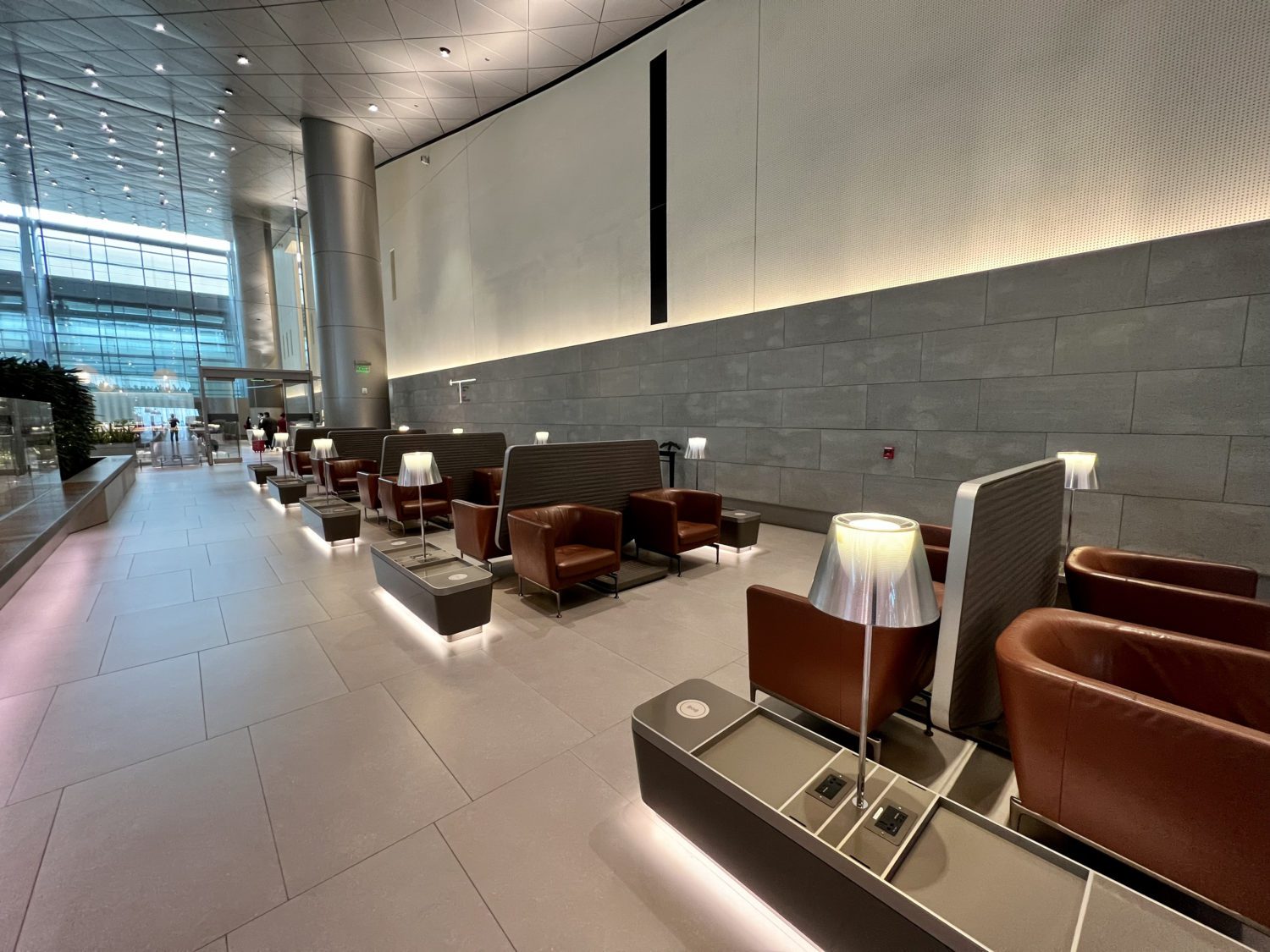 several rows of small armchairs with tables nearby