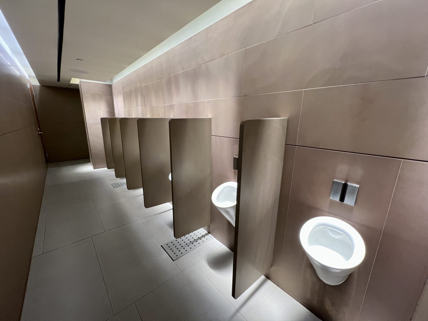 urinals in a stone bathroom