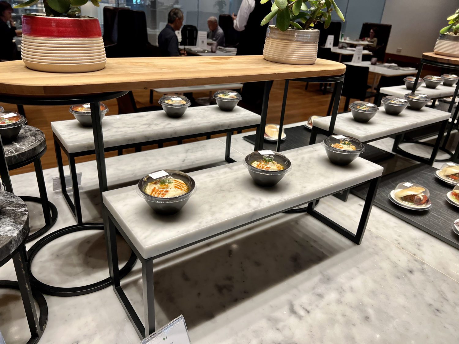 small circular dishes of hummus on a stone display