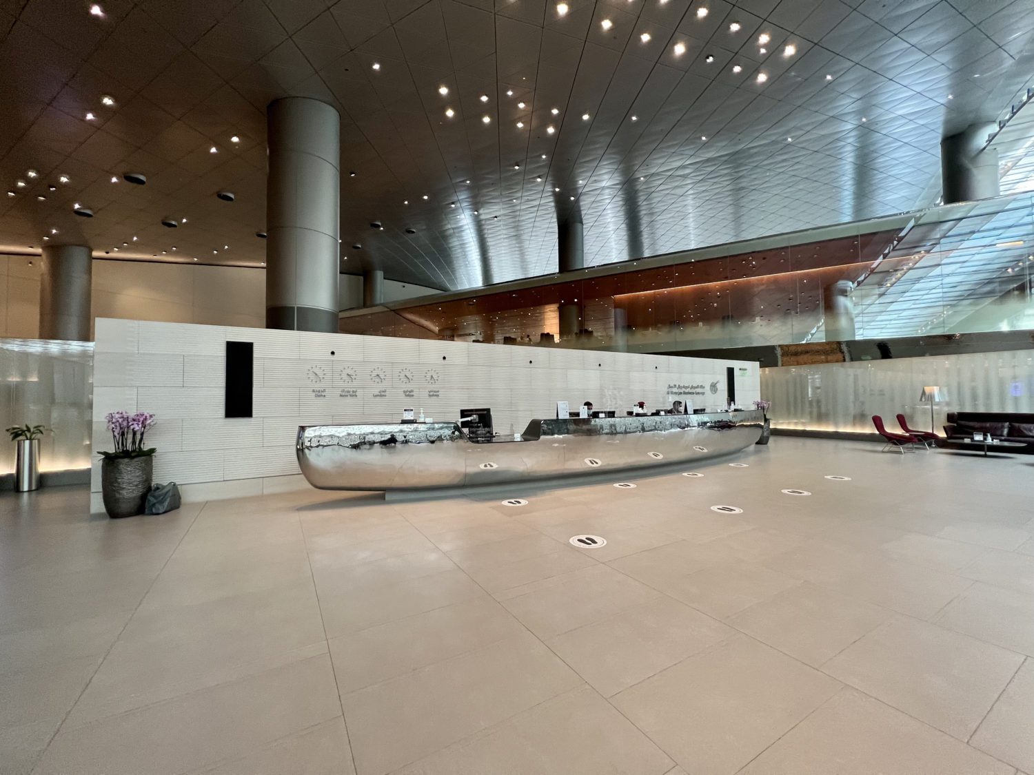 entrance of airport lounge with a long metallic desk