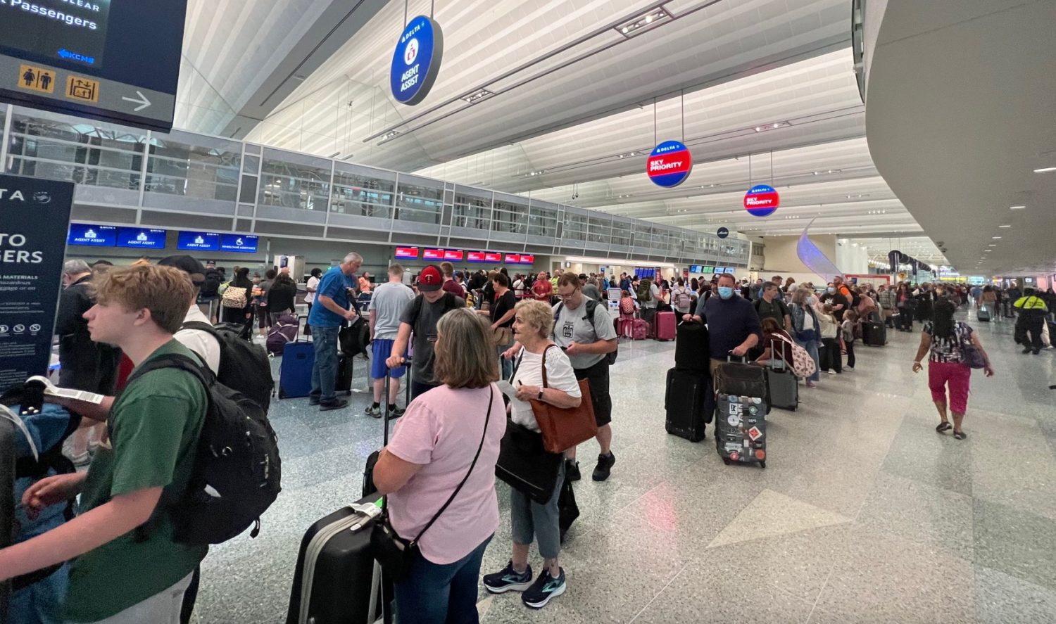 A group of people waiting for their luggage at an airport