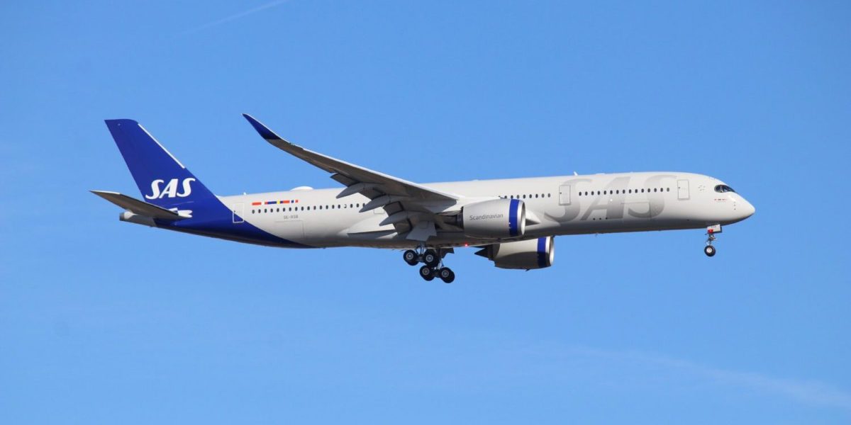 A large passenger jet flying through a blue sky