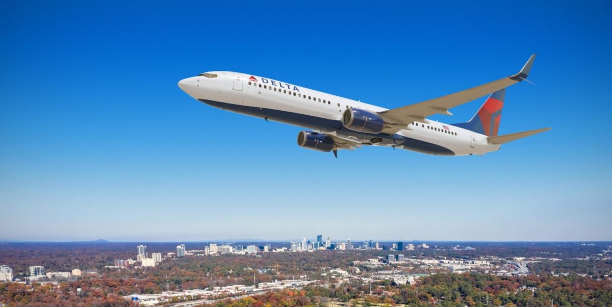 A large delta passenger jet flying through a blue sky
