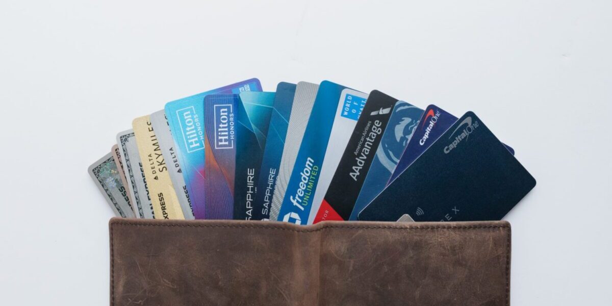An assortment of travel credit cards sticking out of a wallet
