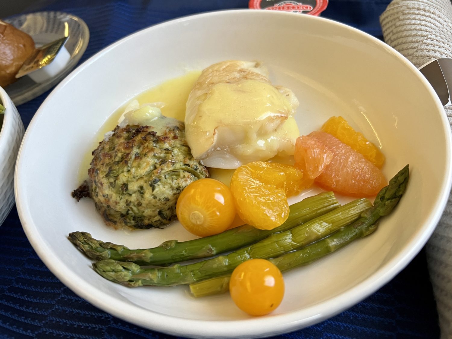 fish in hollandaise sauce with grilled fruits and vegetables