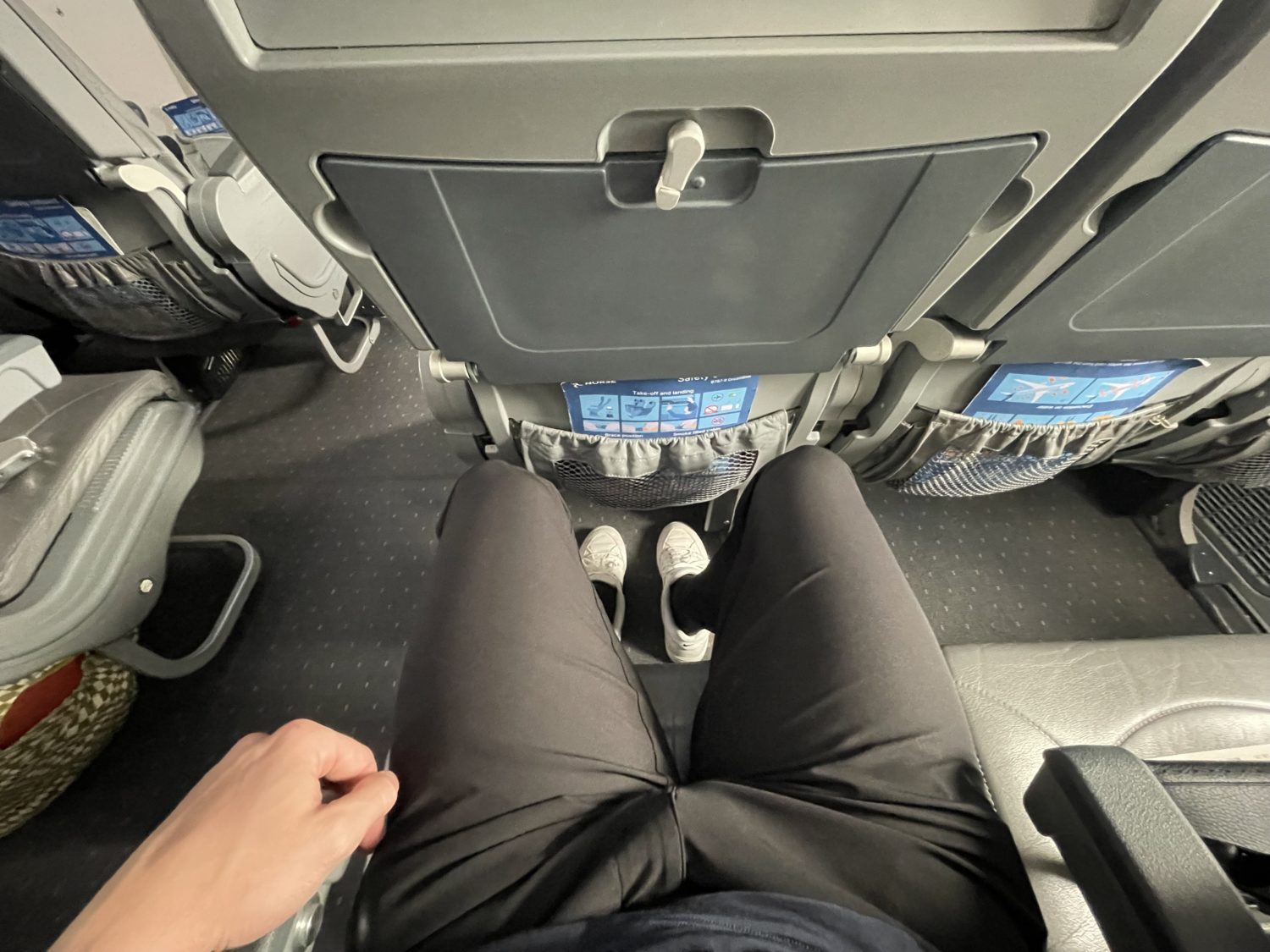 A look down at a passenger's legroom in an airplane seat