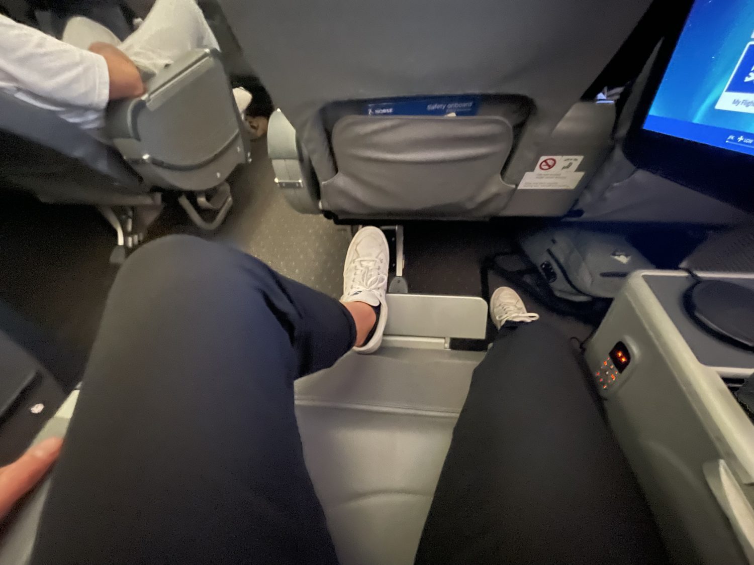 legs and feet on a legrest on the plane