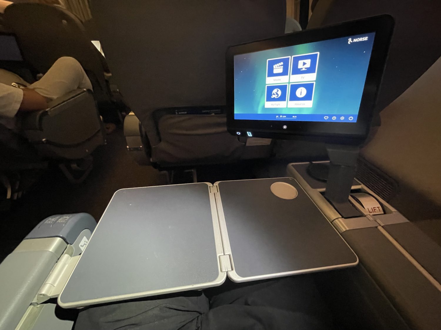 tv screen from the armrest and a tray extended  