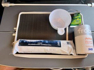 A small pre-landing snack on an airplane, including a juice box. 