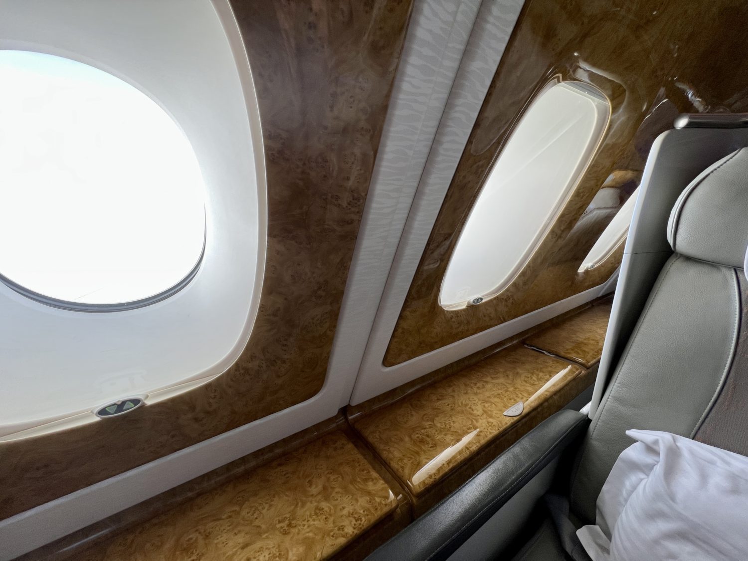 airplane windows and faux wood paneling along the side of a plane