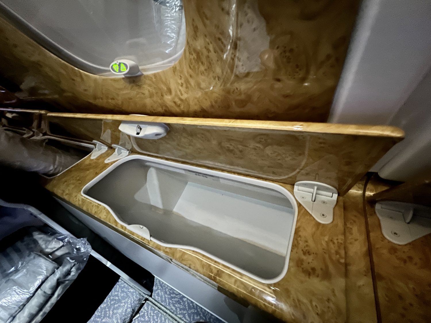 large storage compartments with a door open along the side of a plane