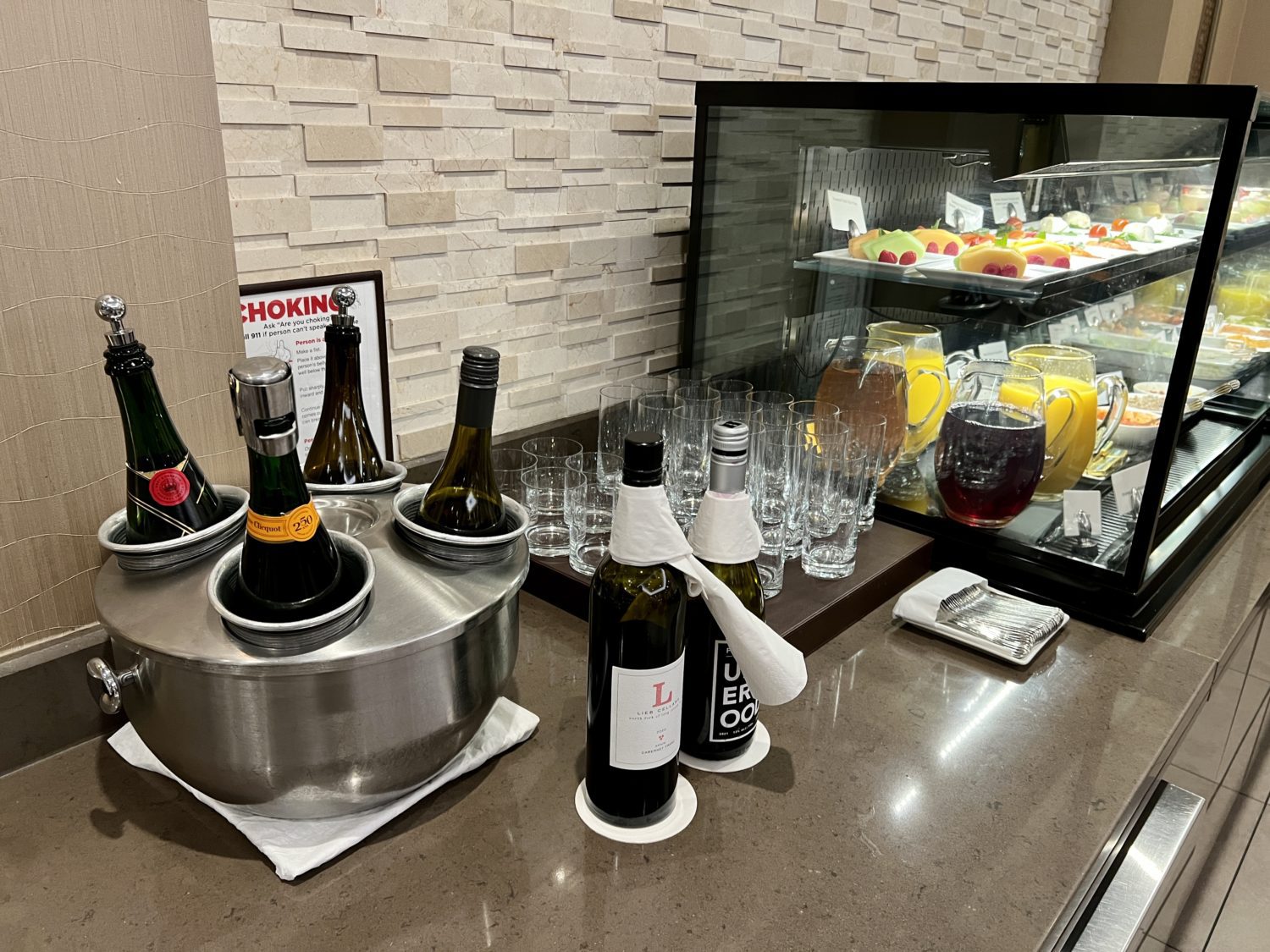 beverage station with several bottles of wine and juice