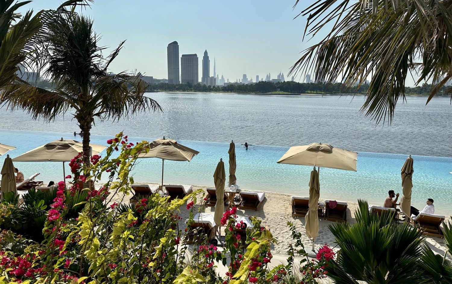 4 Ways to Use Chase Points to Book Hotels 13 a beach with loungers, umbrellas, and an infinity pool