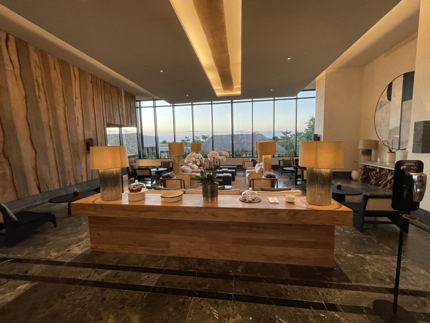 arm chairs and a long wooden console table in a hotel lobby
