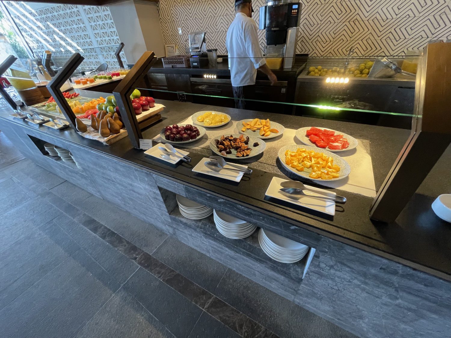 a hotel breakfast buffet with fruit and small bites