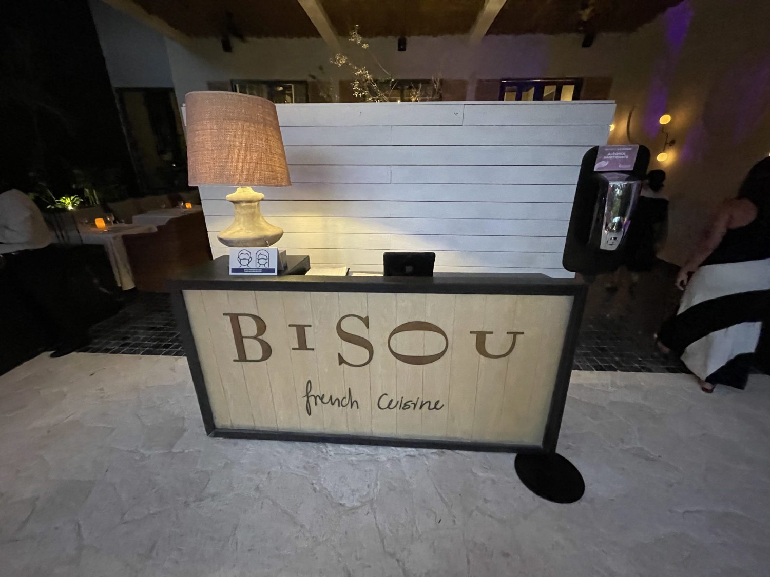 front desk at a restaurant that reads Bisou french cuisine. 