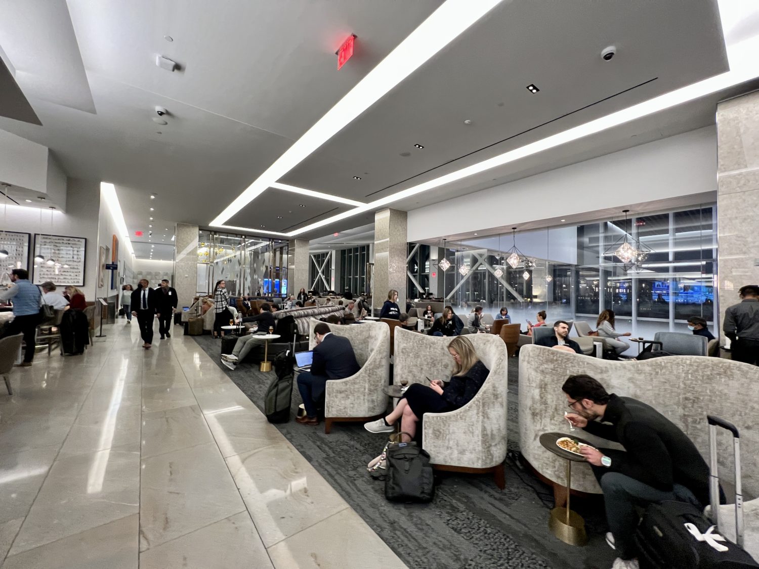 many guests sitting in airport lounge seats