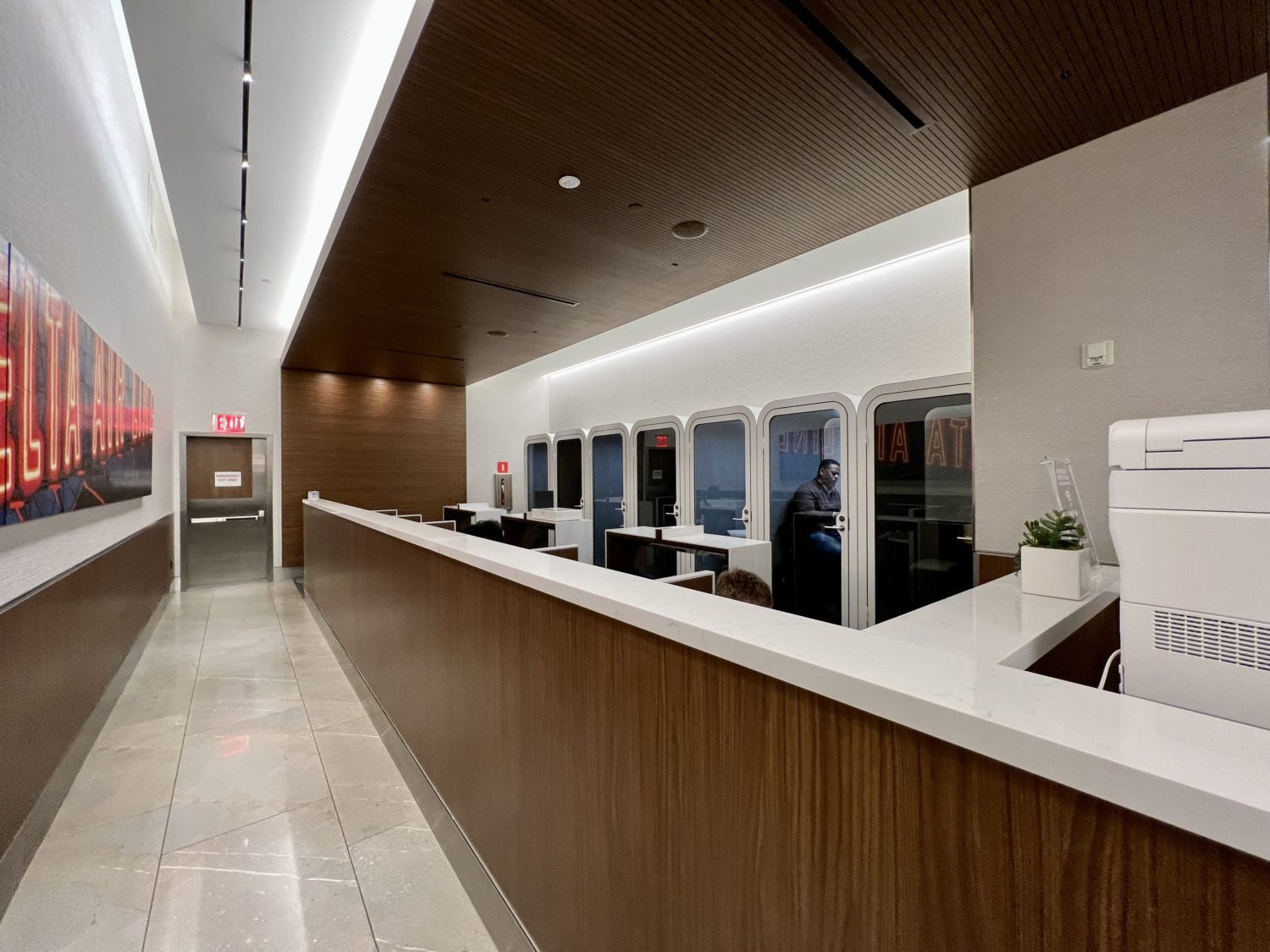 corridor with phone booths and a printer