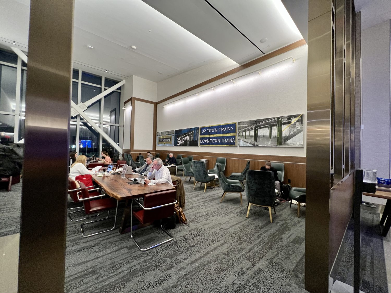 airport lounge guests at a long table