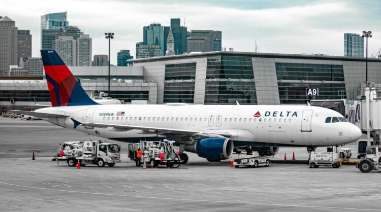 delta airplane waiting at the airport gate