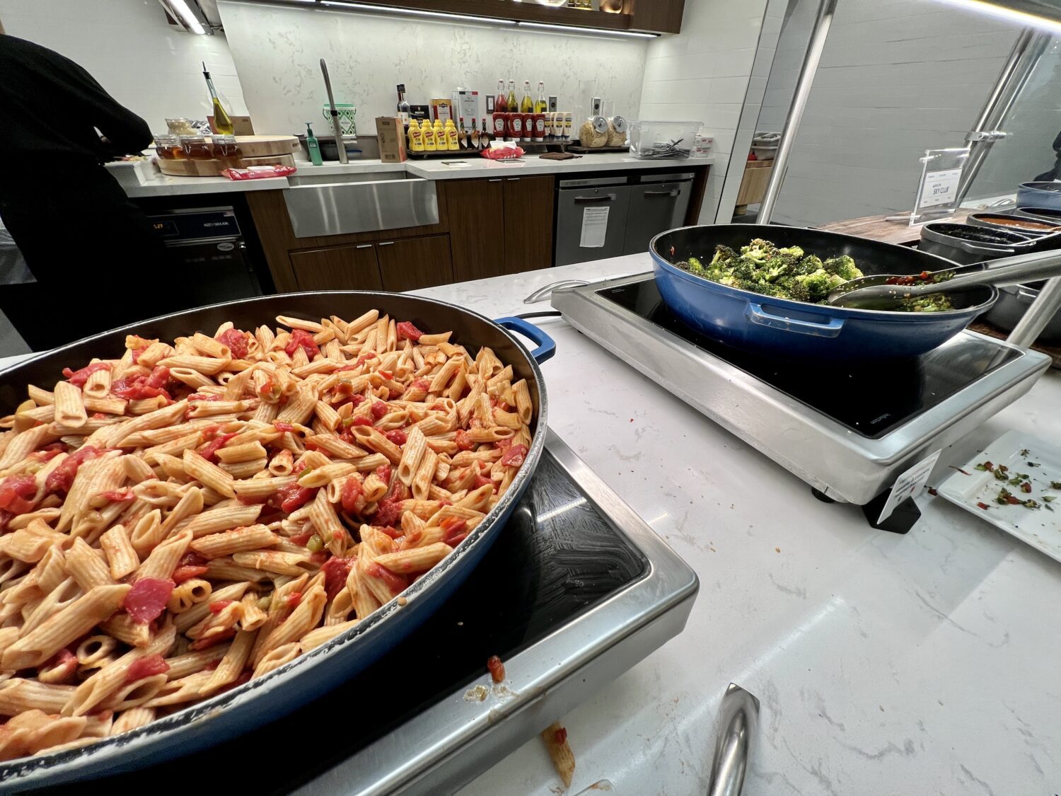 Large containers of pasta and broccoli