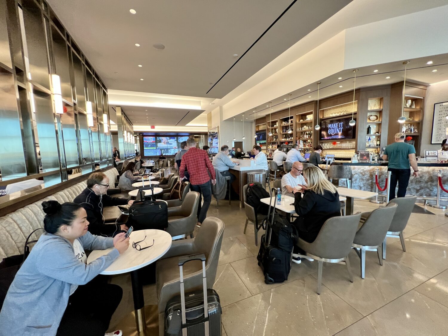 dining room area full of guests and a bar in the background