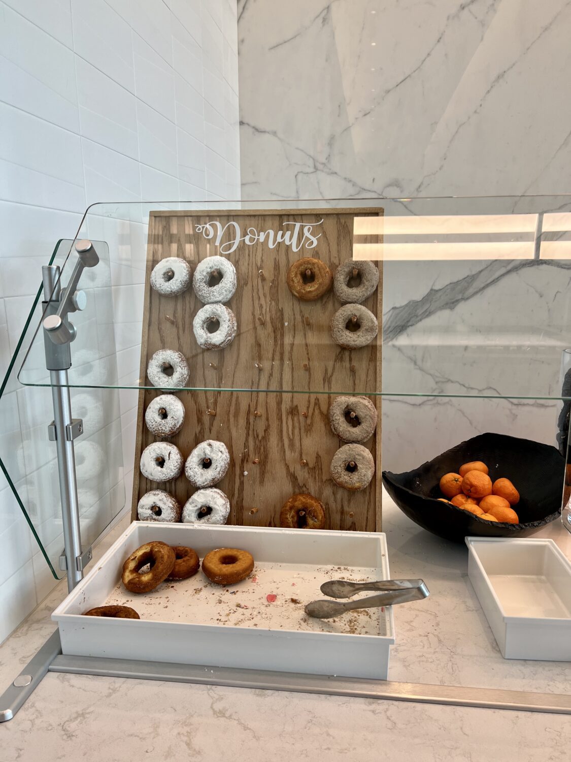 donut board with several donuts hanging on wood pegs