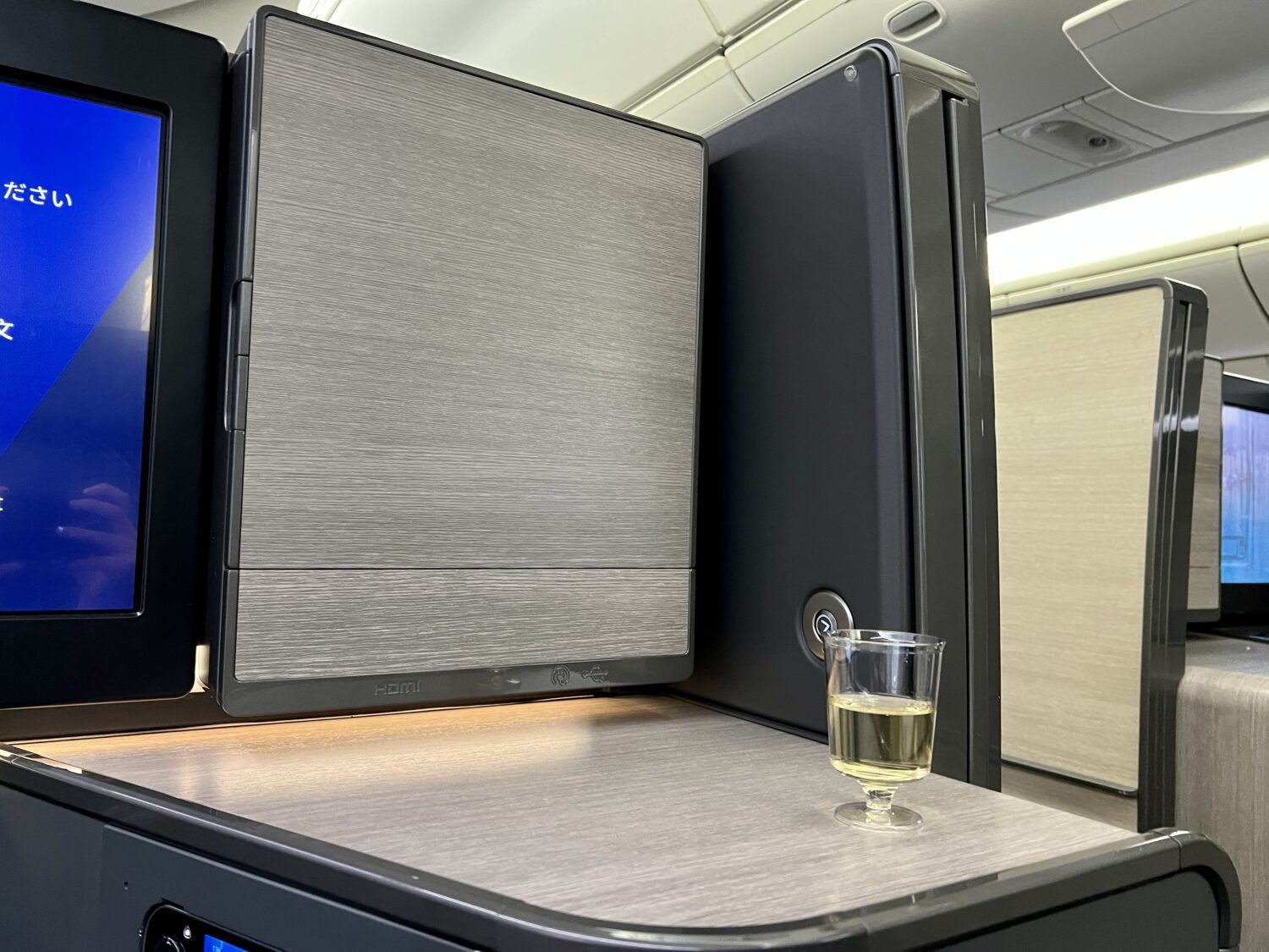 plastic glass of champagne inside a business class suite