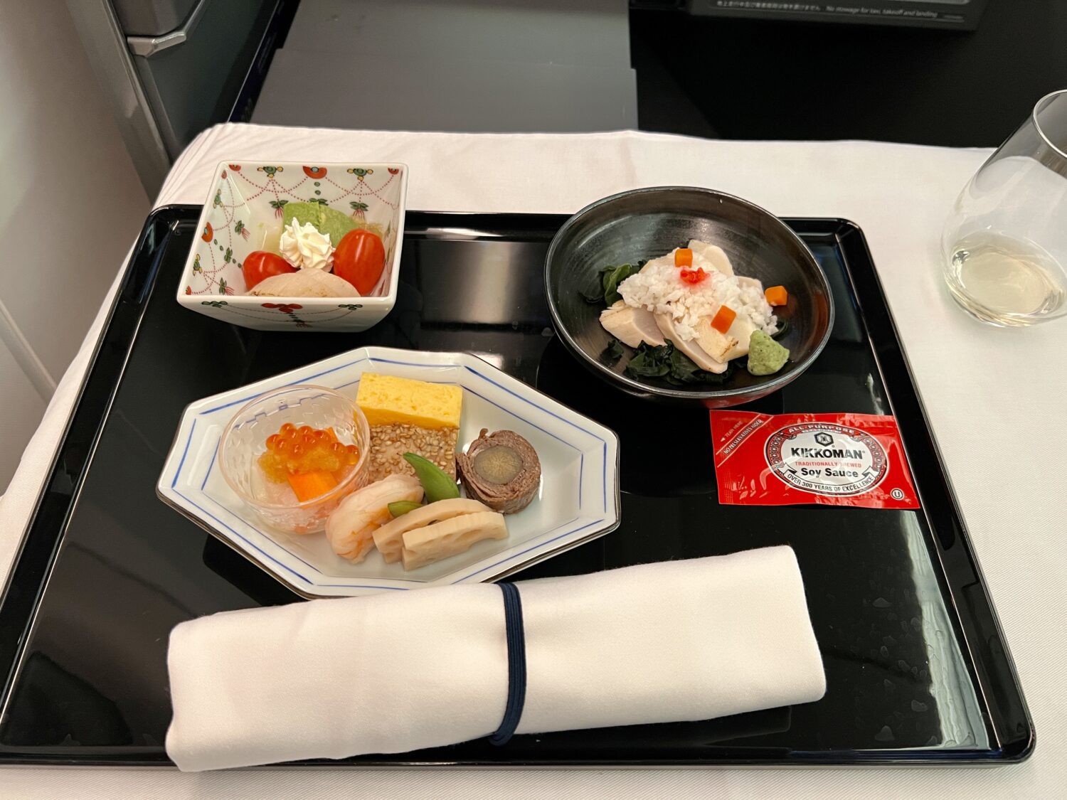 tray of japanese dishes with soy sauce