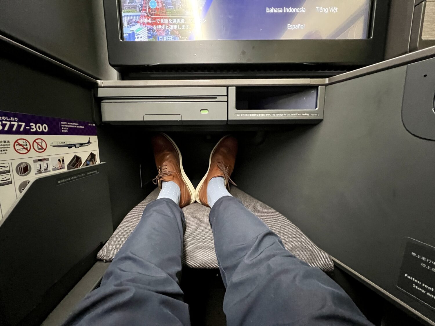business class footwell with legs inside of it