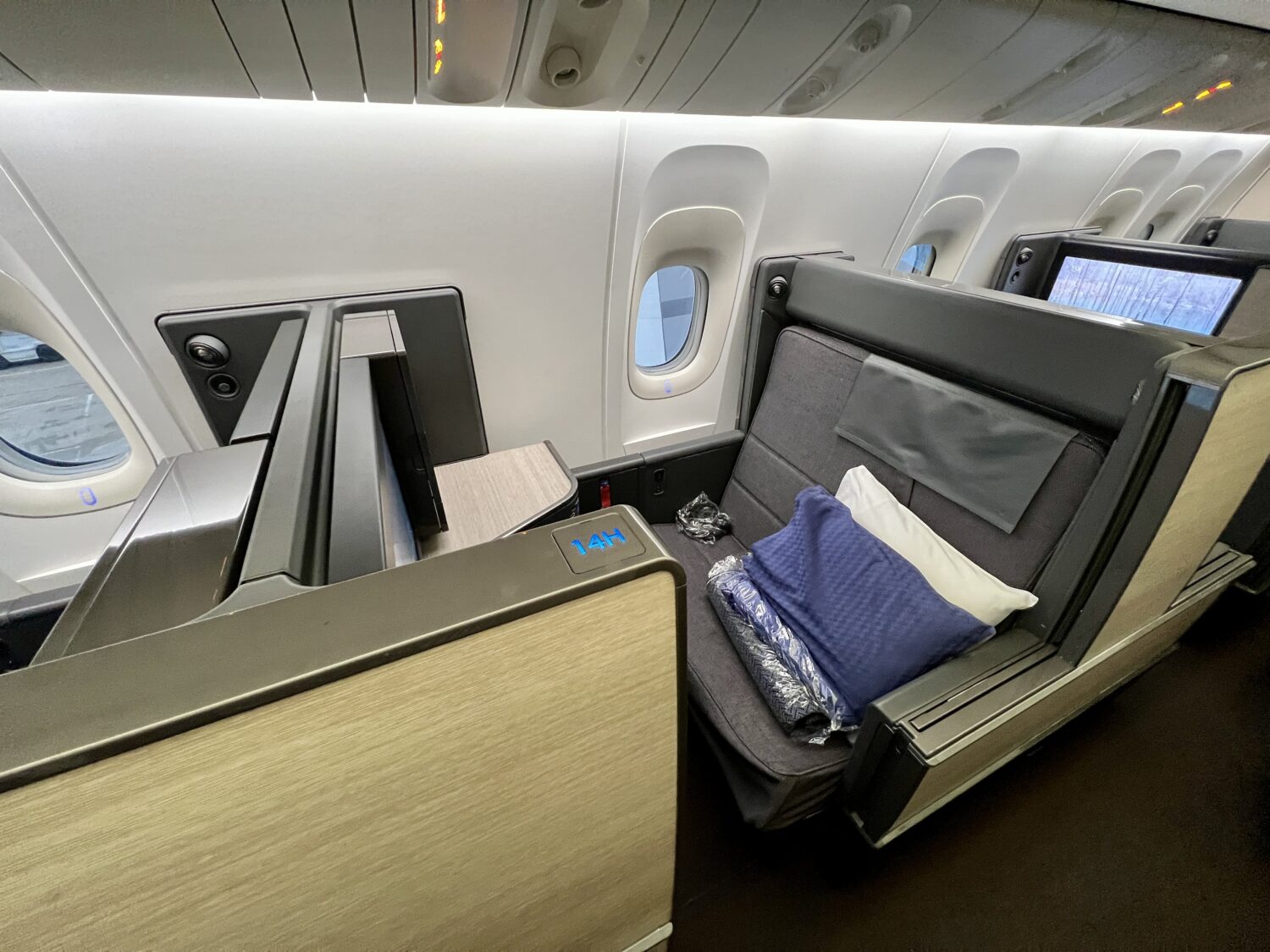 business class suite with pillows and blankets