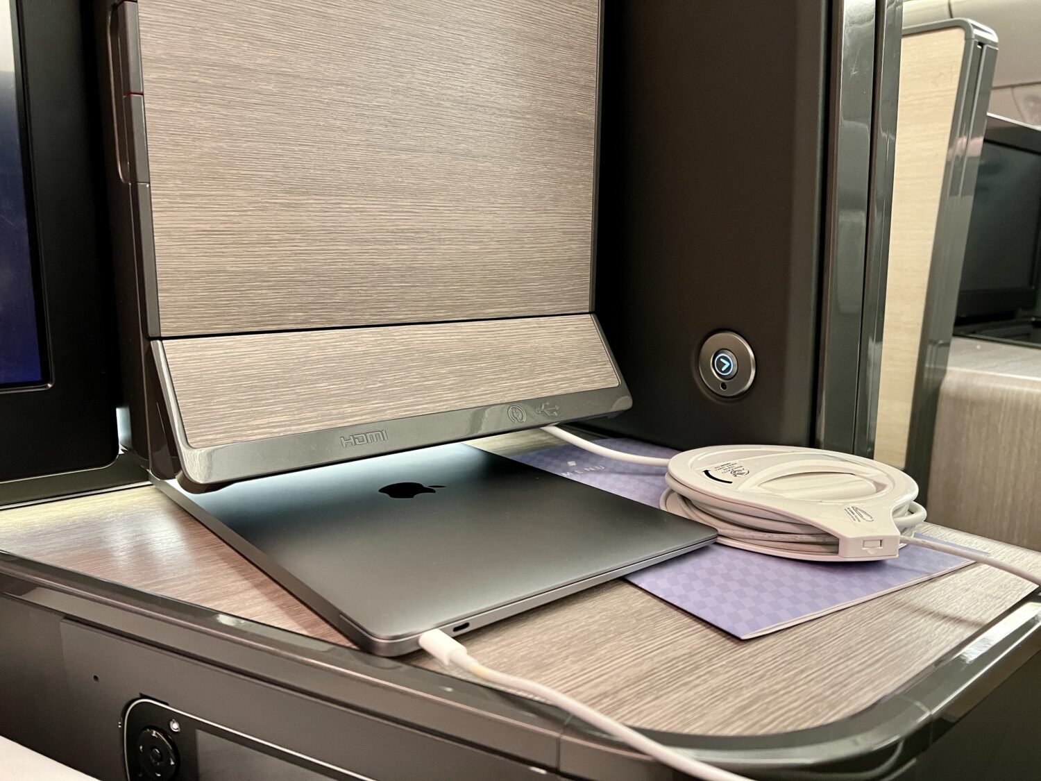 laptop plugged in on a plane