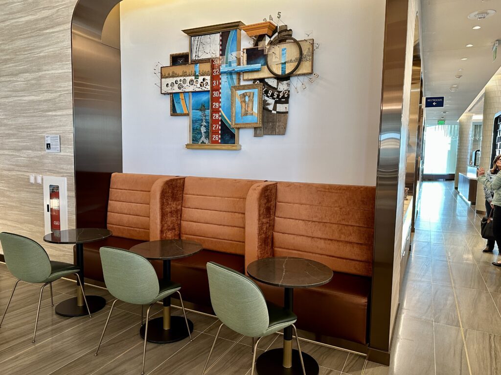 A restaurant with a stunning art piece on the wall