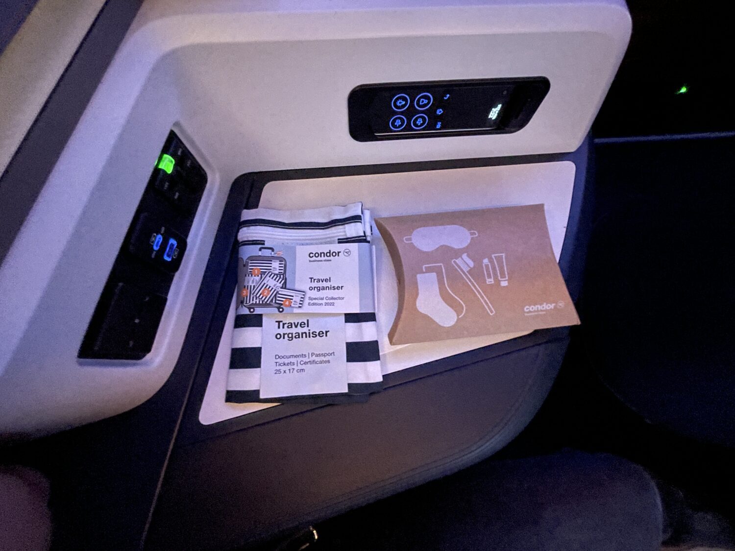 Condor travel organizer and cardboard box with socks, a toothbrush, eye mask and toothpaste