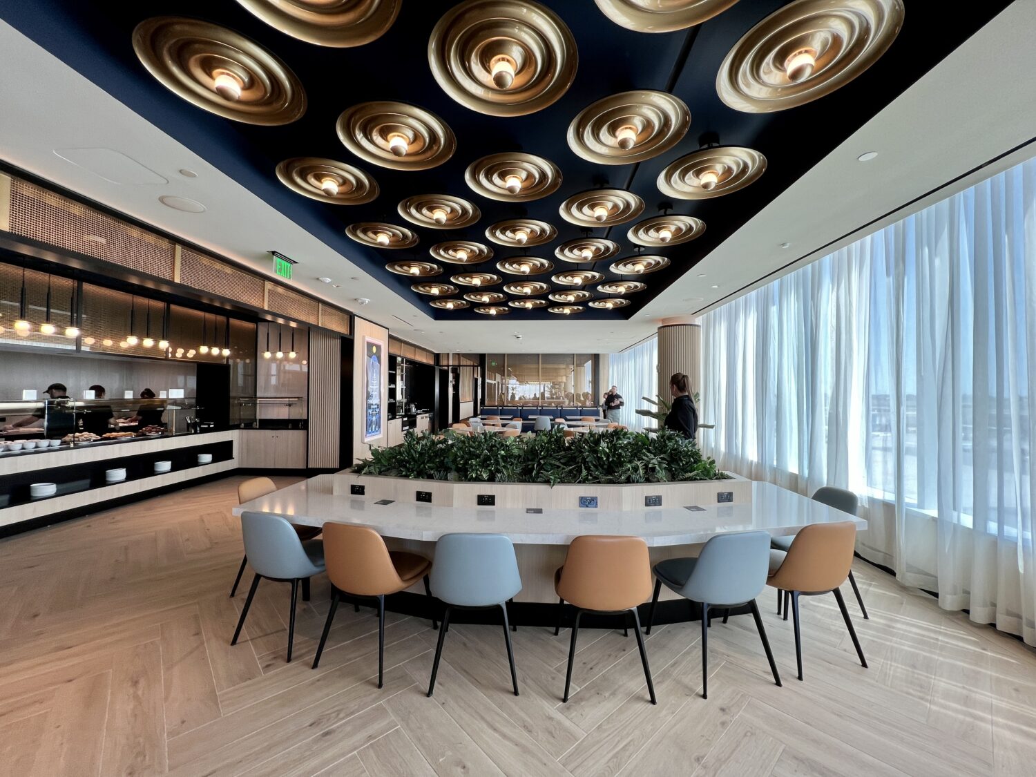 A modern office with a circular table and chairs